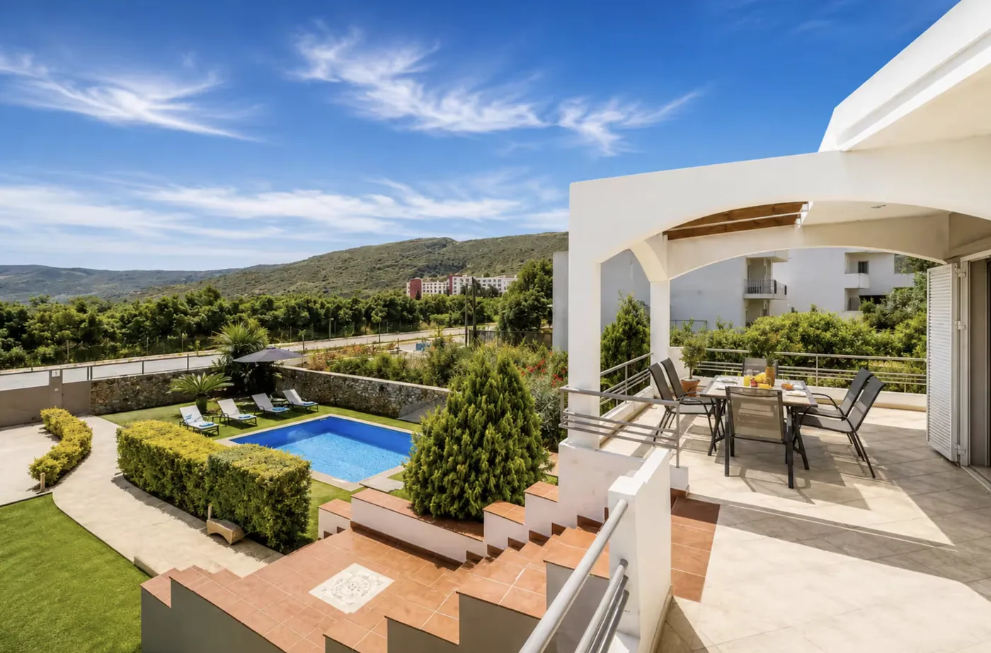 View from the villa over the pool, garden and the hills of Mournies